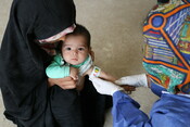 Aalem* being checked for signs of malnutrition by the mobile health worker. 