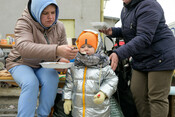 Veronika* feeds her child Aleksander* at the temporary refugee station in Medyka, Eastern Poland, on 2 March 2022.