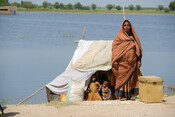 Soni, 37, stands with her family in front of her temporary shelter