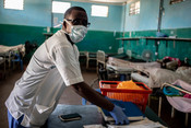 Abdi Ali, a nurse at Keysaney hospital wears a mask as he attends patients.