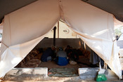 Mohammed Mardabsawi's family eats lunch in their tent in Zaitoun Maarshurin refugee camp