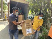 Oxfam staff carry an oxygen concentrator